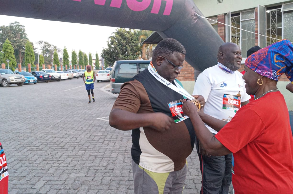 Medal presentation ceremony at the finish line with participants and supporters