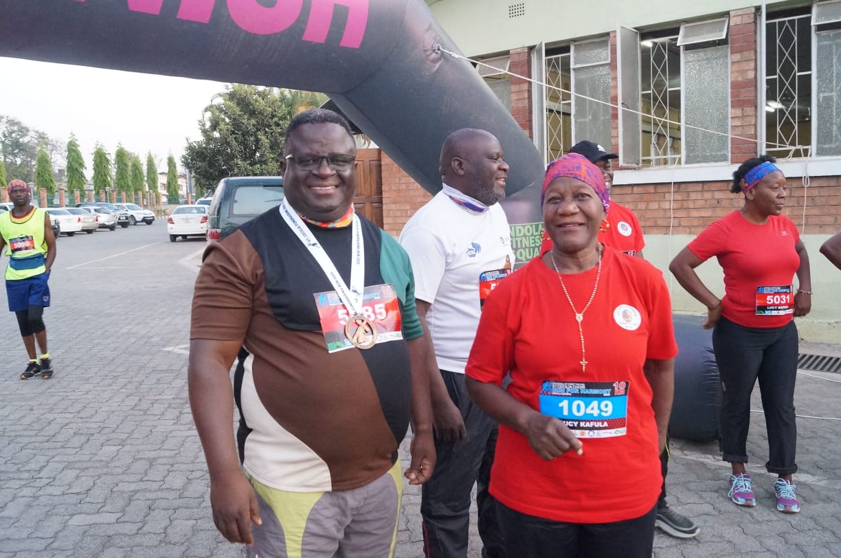 Proud participants posing with medals at the finish line after completing the fundraising run